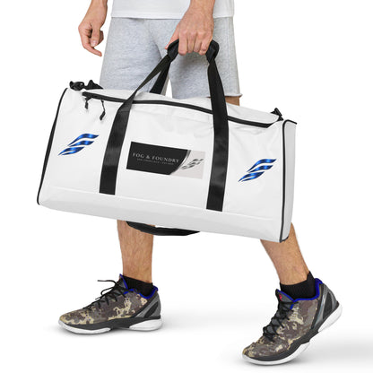 Large Fog & Foundry Performance+ Duffle Bag with all-over white print, showcasing sturdy handles and spacious design.
