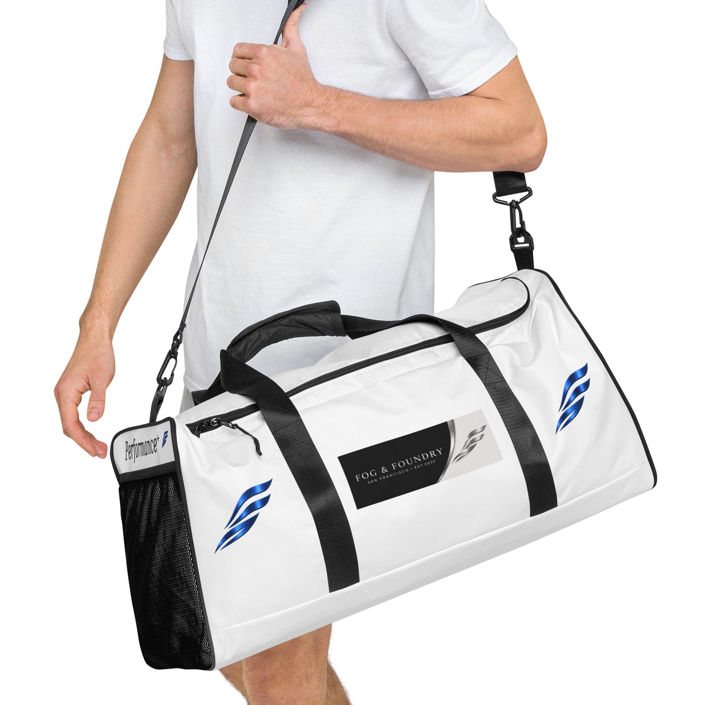 Large Fog & Foundry Performance+ Duffle Bag with all-over white print, showing the side view with handles and zipper detail.
