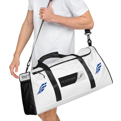 Large Fog & Foundry Performance+ Duffle Bag with all-over white print, showing the side view with handles and zipper detail.