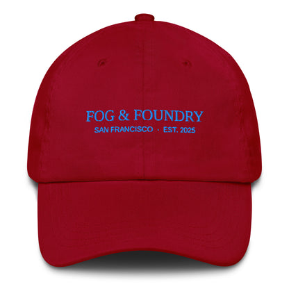 Red embroidered dad hat by Fog & Foundry with a classic six-panel design and curved brim, front view.