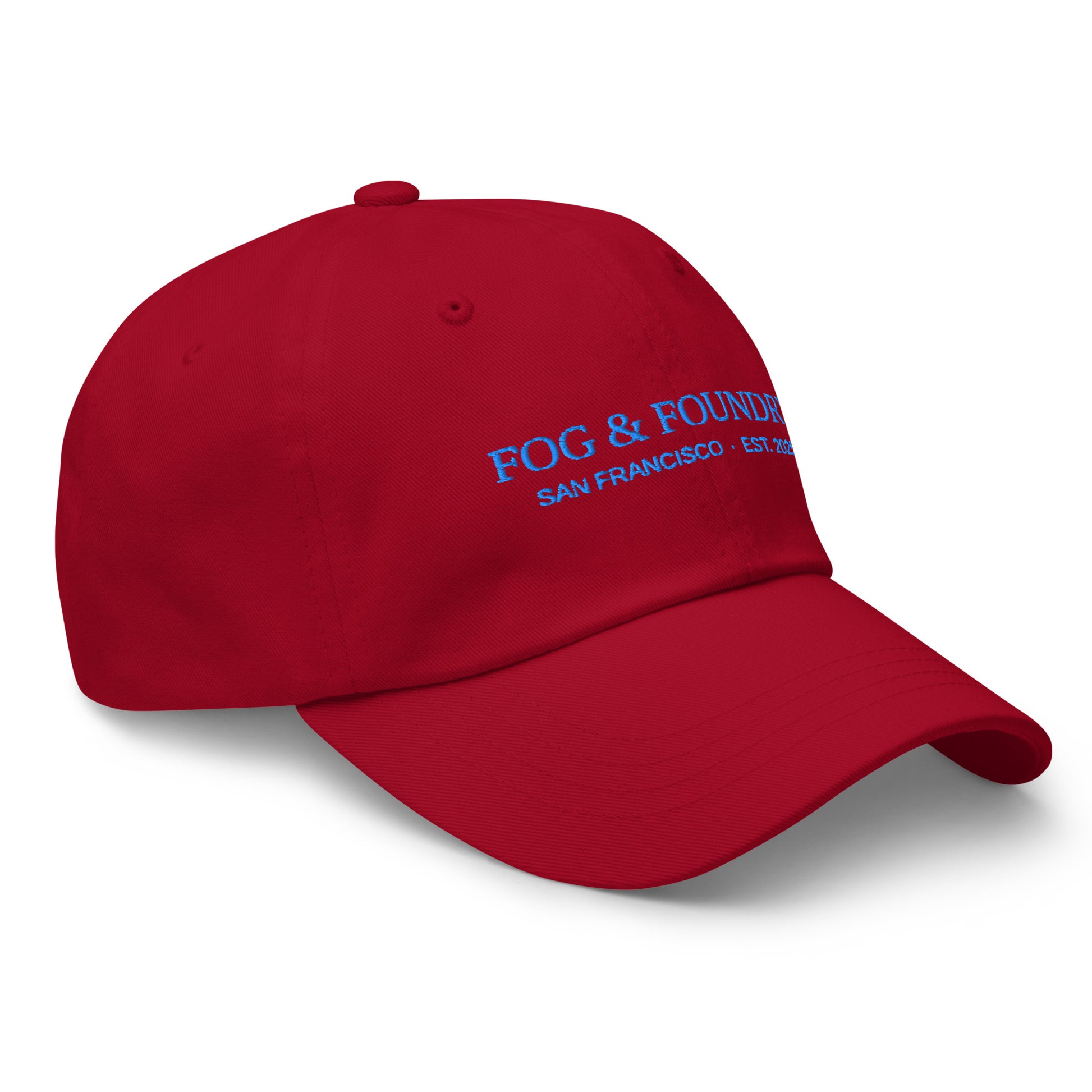 Front view of a cranberry-colored embroidered dad hat by Fog & Foundry with a curved brim and classic baseball cap style.