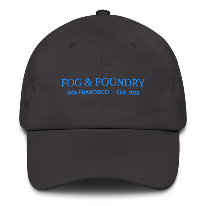 Dark grey embroidered dad hat by Fog & Foundry featuring classic sportswear style and front stitch detail.