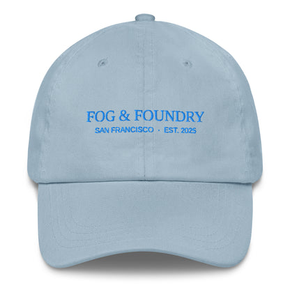 Light blue embroidered dad hat by Fog & Foundry featuring classic sportswear style and front stitching detail.