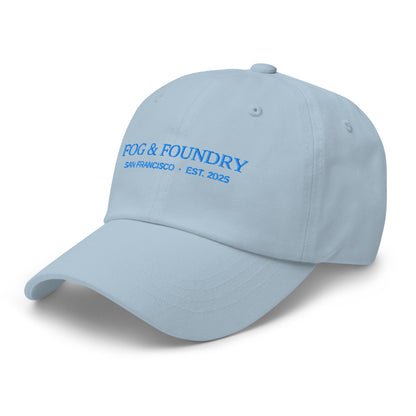 Light blue embroidered dad hat from Fog & Foundry, featuring classic sportswear style with front embroidery detail.