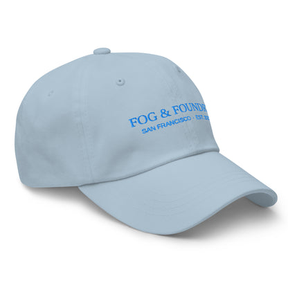 Light blue embroidered dad hat by Fog & Foundry, featuring classic sportswear style and adjustable front panel.