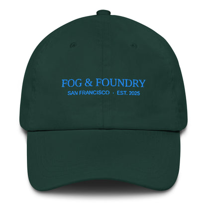 Embroidered classic dad hat from Fog & Foundry with a spruce color, featuring a front embroidered logo and adjustable strap.