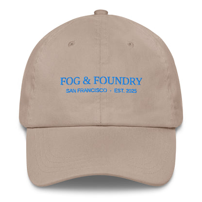 Embroidered classic dad hat from Fog & Foundry in stone color, featuring a front embroidery logo and adjustable strap.
