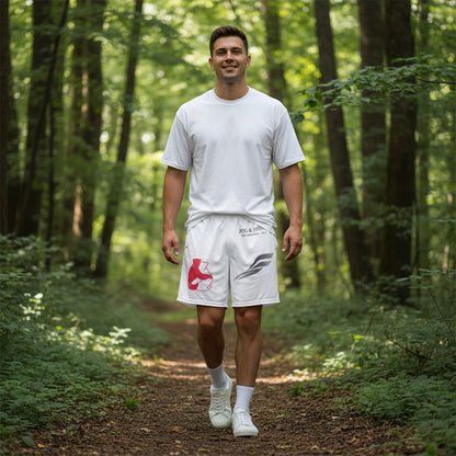Man wearing Fog & Foundry Bougainvillea Trail Shorts with graphic print while walking on a forest trail