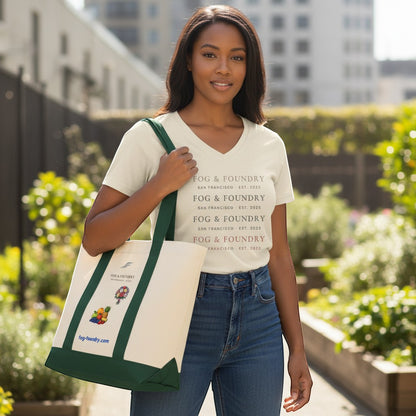 A woman wearing a Fog & Foundry branded t-shirt carries a heavy-duty cotton twill tote bag with a green base.