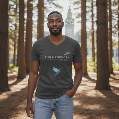 A man wearing a Fog & Foundry gray v-neck cotton t-shirt with a hummingbird logo in a redwood forest setting.