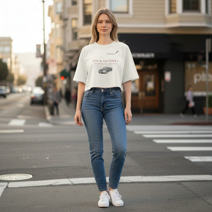 Fog & Foundry white cropped cotton tee with Mercedes graphic, worn by a woman with blue jeans on a city street.