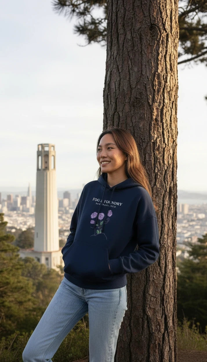Fog & Foundry navy organic cotton mid-length hoodie with floral graphic, worn by a woman overlooking San Francisco.