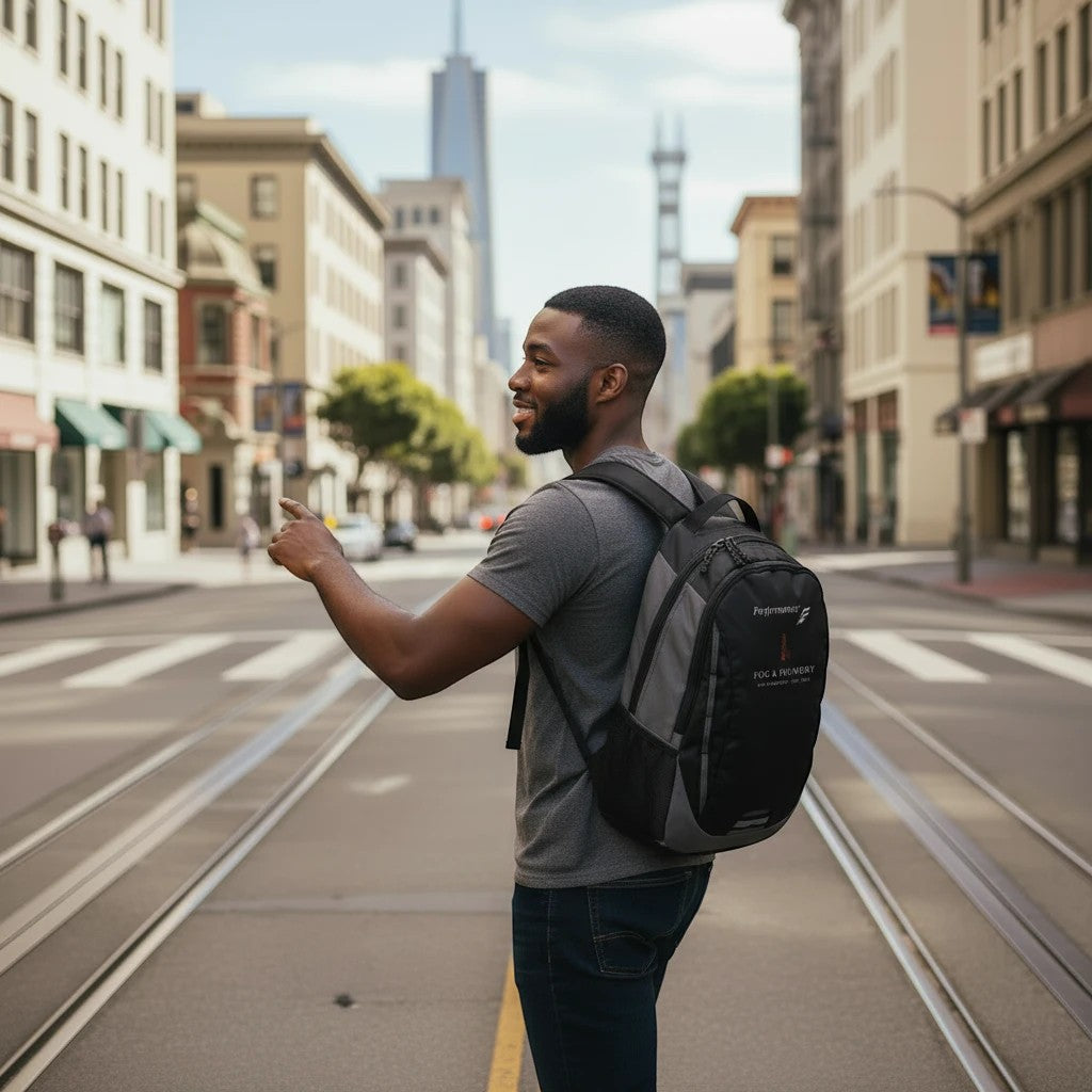 Man wearing a Fog & Foundry Ridge backpack while walking on a city street, showcasing the black and grey design.