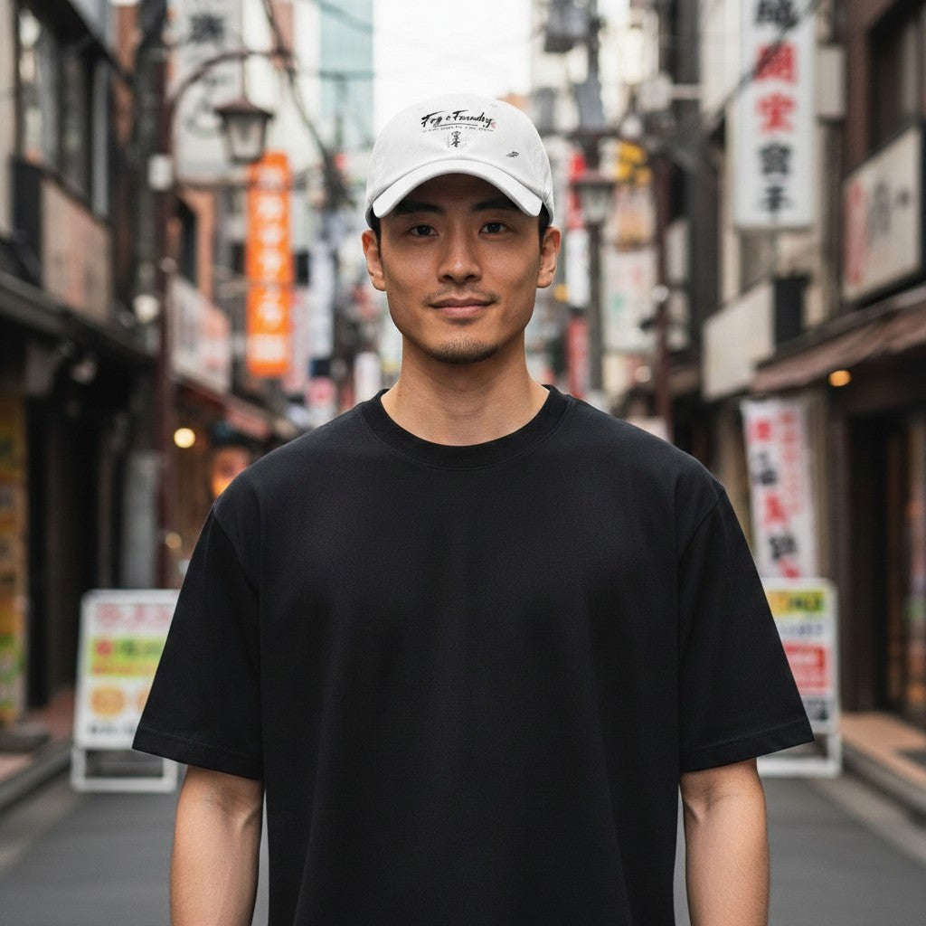Man wearing a white Fog & Foundry Japan cap with a curved visor and embroidered logo in a Japanese street setting.