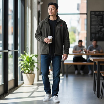 Man wearing a Fog & Foundry olive green fleece jacket with a full-zip front and collar, styled with jeans in a cafe.