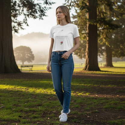 Model wearing a white Fog & Foundry crop tee with a hand-drawn bloom graphic in a misty park setting.