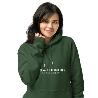 Unisex organic cotton raglan hoodie in bottle green from Fog & Foundry, front view showcasing casual style and eco-friendly fabric.